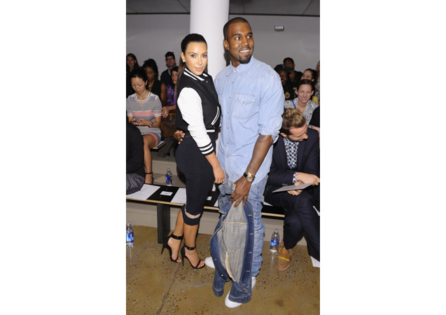 Kim and Kanye are all smiles in a varsity-inspired look and denim-on-denim at Milk Studios.