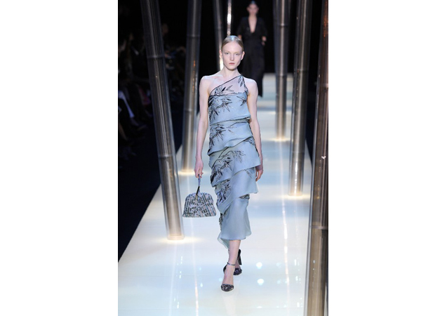Armani Privé's tiered dress creates playful movement on the runway.