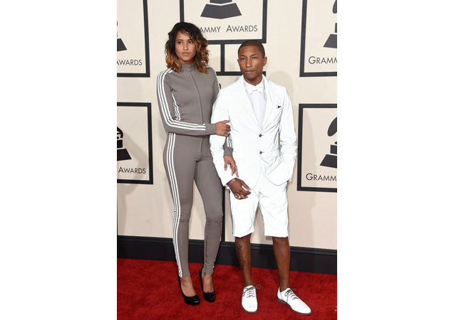 Helen Lasichanh wearing a hideous grey tracksuit-jumpsuit hybrid. So bad that even having Pharrell on her arm can't help. 