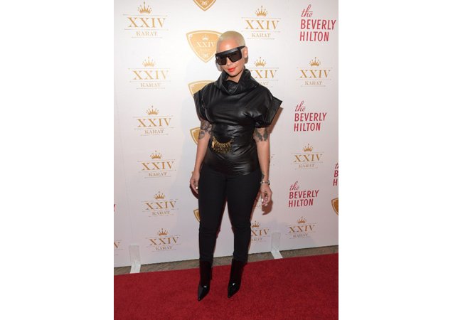 Amber flops in this weird pleather ensemble at the XXIV Karat Launch Party.