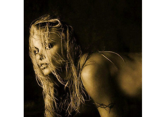 Pamela Anderson's barb wire tattoo is so masculine it makes it easy to mistake her arm as a mans. Photo courtesy of Pamela Anderson via [link href='https://instagram.com/pamelaanderson' target='_blank']Instagram[/link].